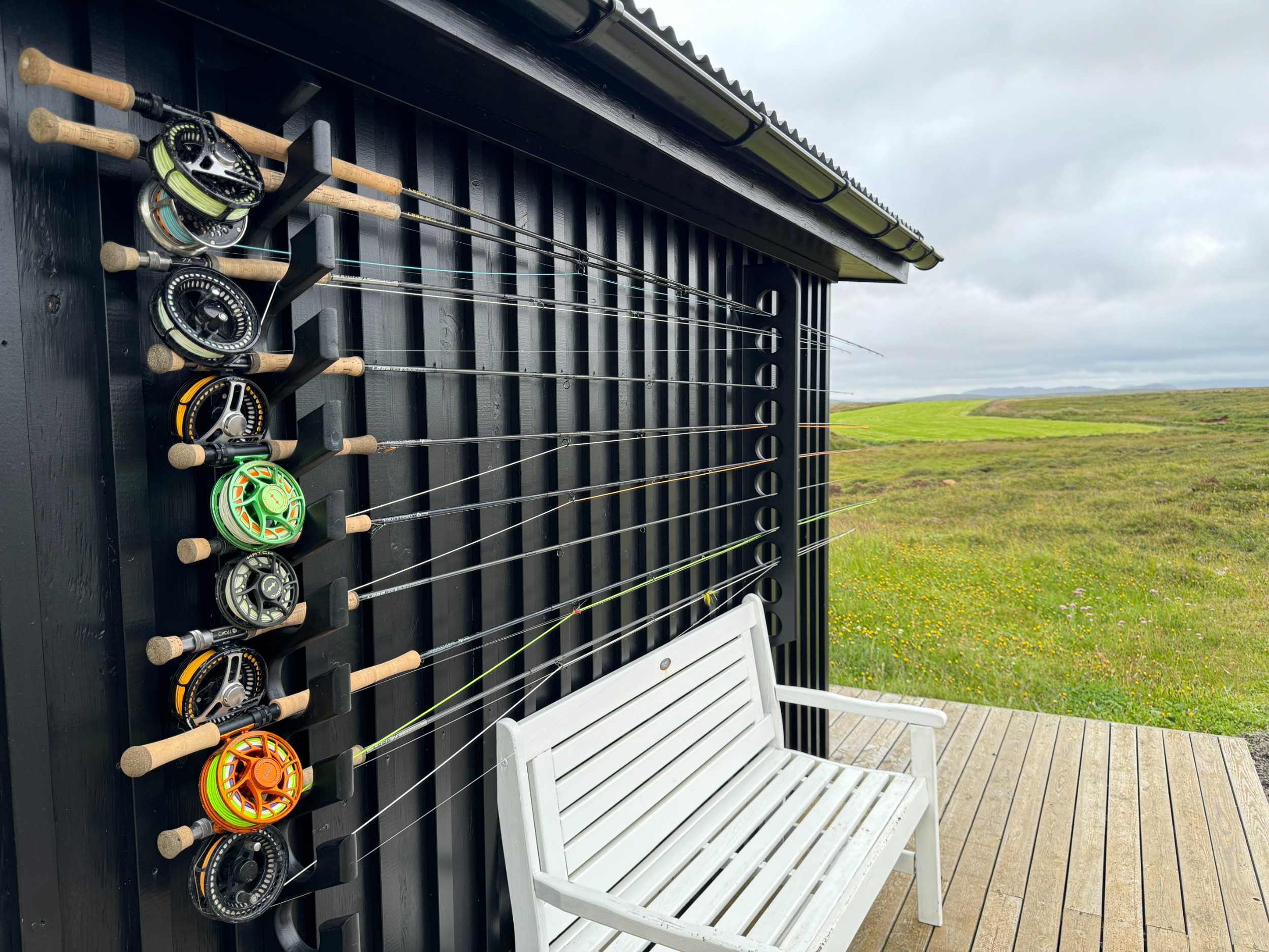 Several fishing poles on a rack outside a lodge in Iceland.