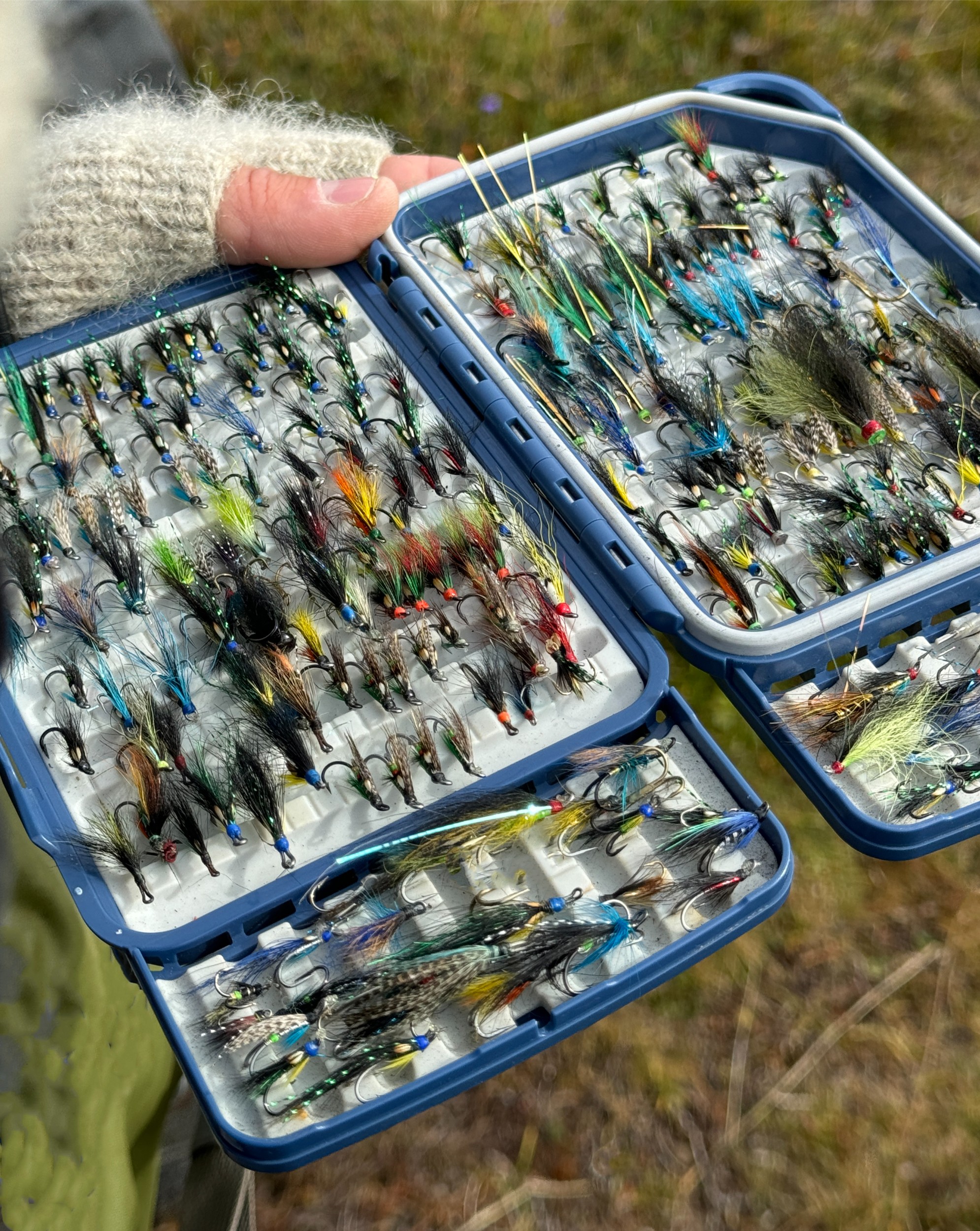 A case full of dozens of handcrafted fly fishing flies.