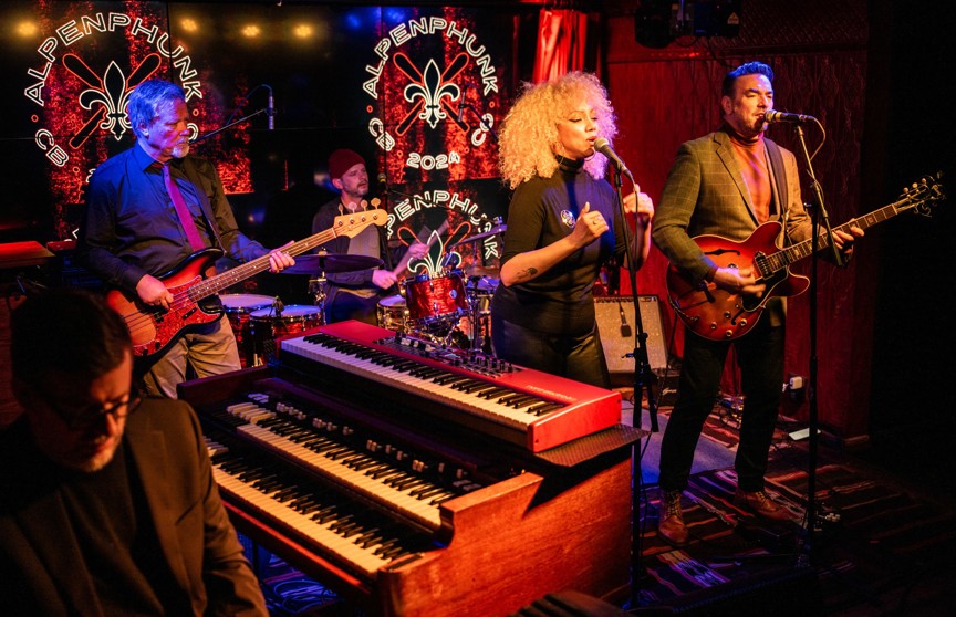 A band performing in an intimate bar under bright lights.