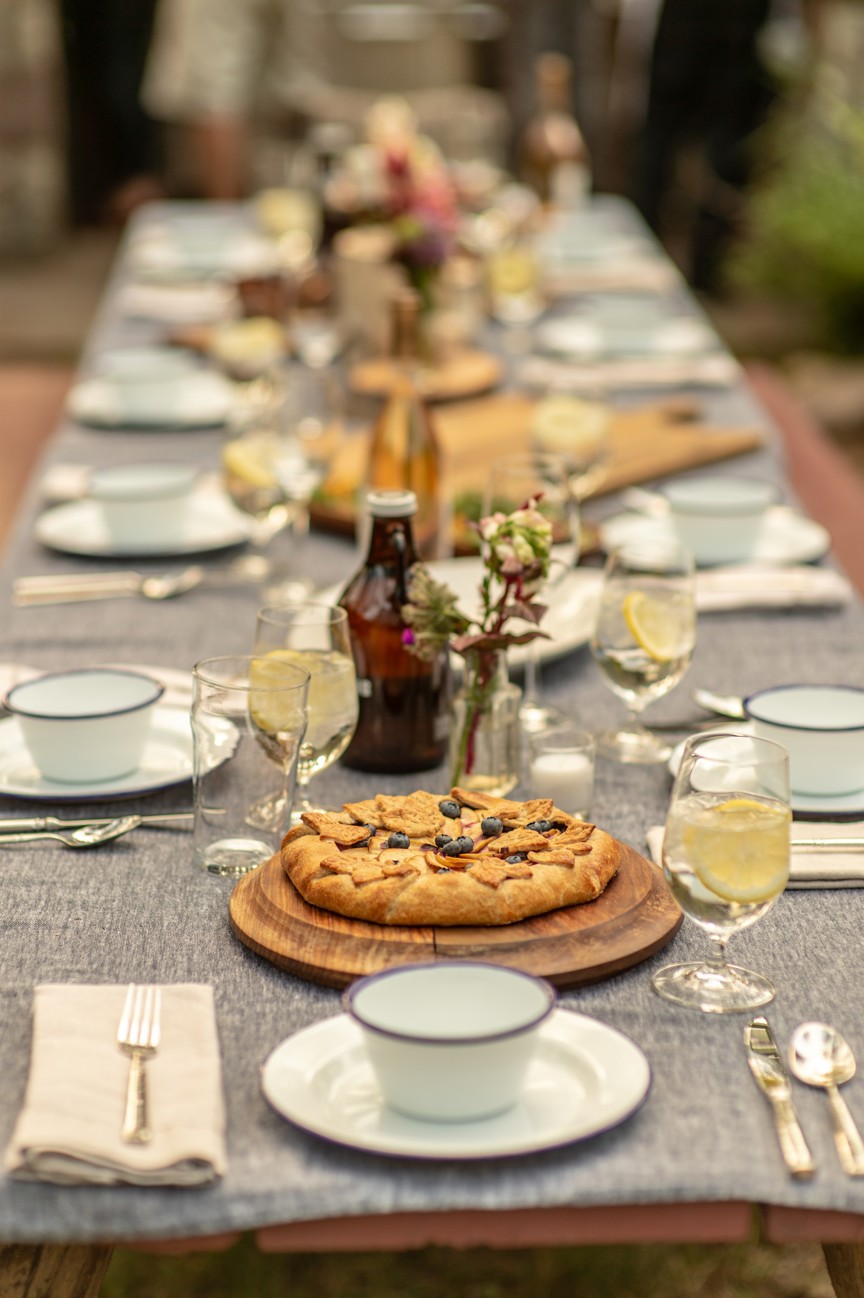 A berry pastry set in the middle of a large dining table.