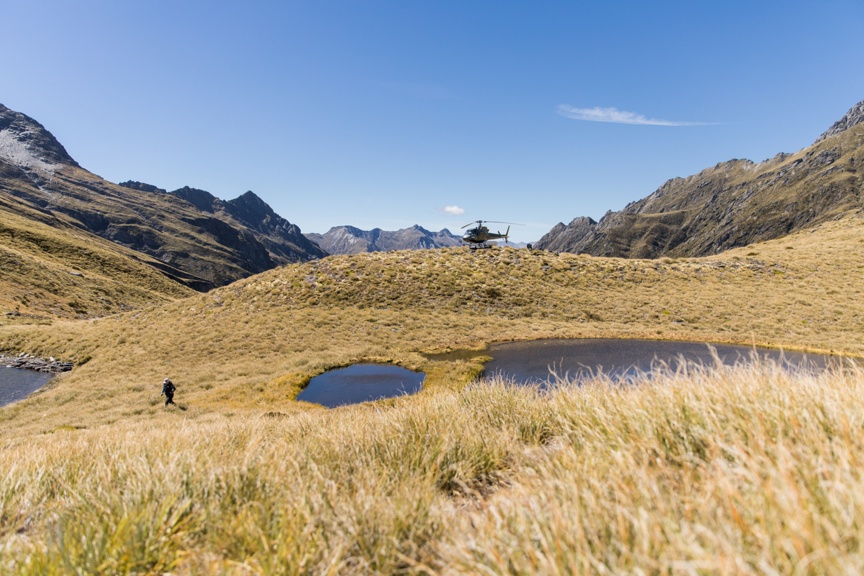 A helicopter lands after a scenic tour in New Zealand.