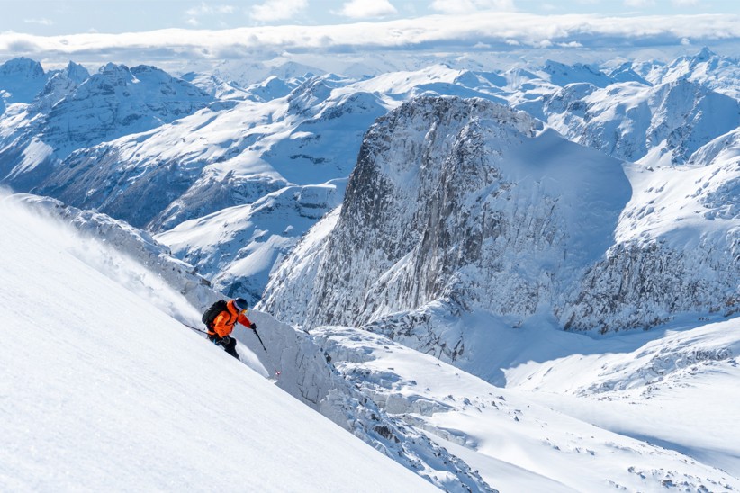 A person skiing downhill in a Chilean mountain range.