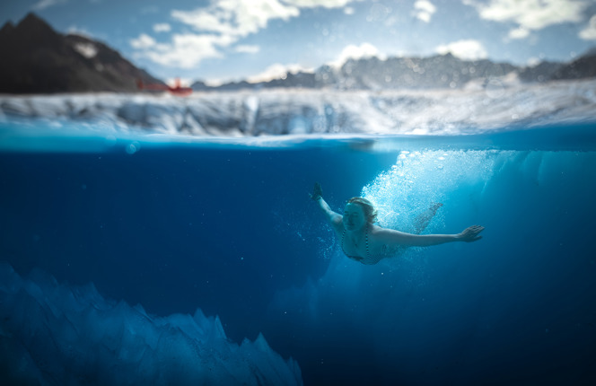 Woman Diving in Glacier Water in Alaska