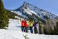 A group of friends celebrating half way down a ski mountain.