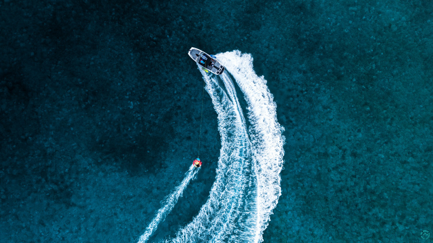 Tubing behind wake boat in Bahamas.