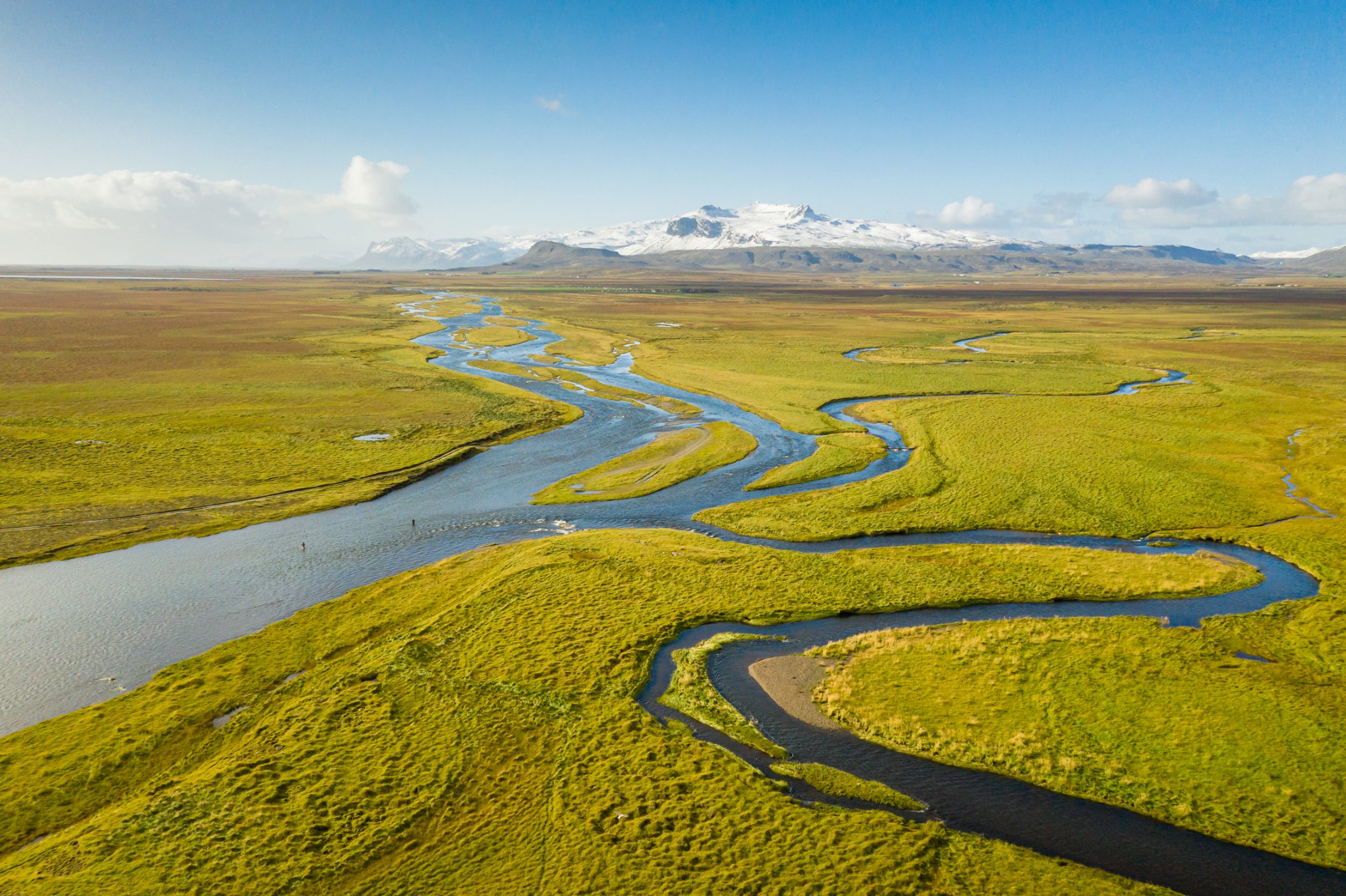 The Husey River in Iceland meanders through a field.