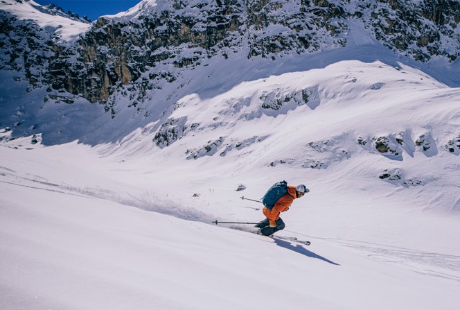 A skier headed down a mountain.