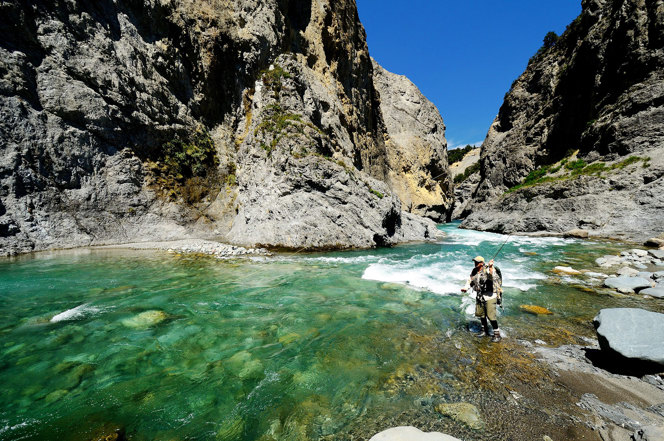 Man angling in a remote New Zealand river