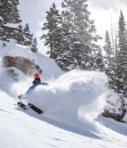 A skier skidding to a stop head downhill on Mount Irwin.
