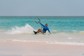 A person kite surfing on a beach in the Bahamas.