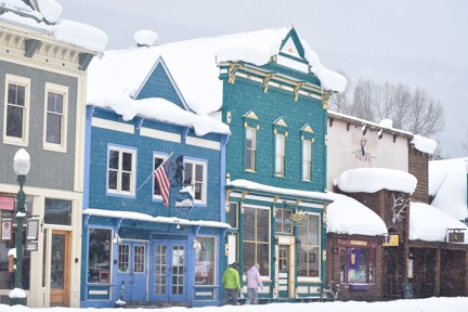Storefronts in a snowy downtown in Crested Butte.