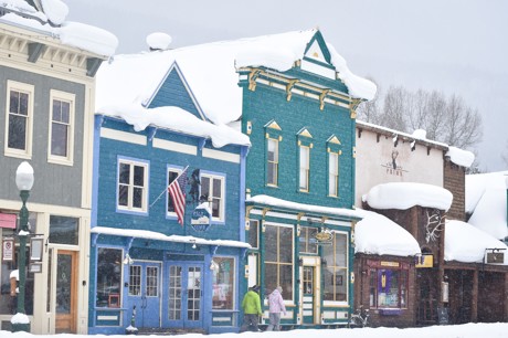 Storefronts in a snowy downtown in Crested Butte.
