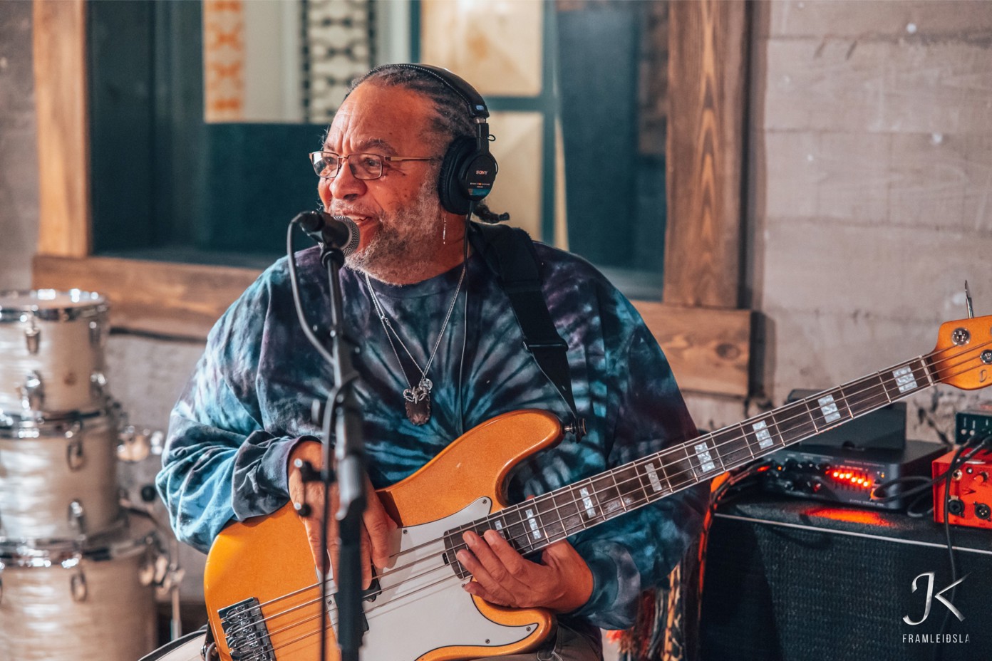 A bass player talking to his bandmates.