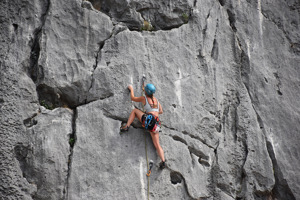 Woman rock climbing in the mountains.