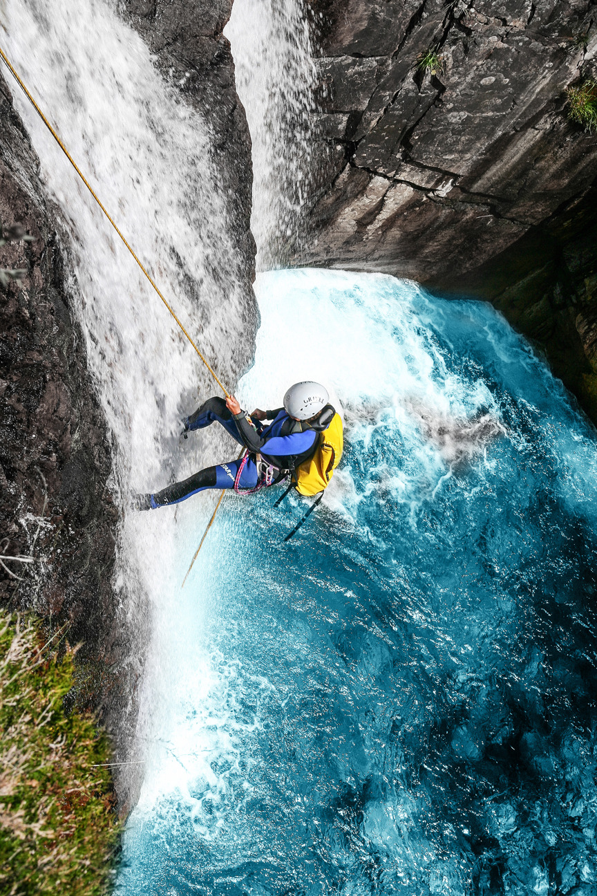 Person abseiling in canyon.