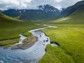 A few people on stand up paddle boards on a creek in Iceland.